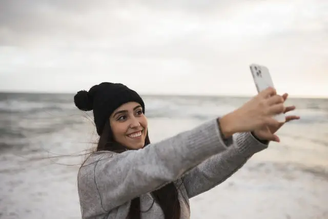 Woman taking a selfie at the beach